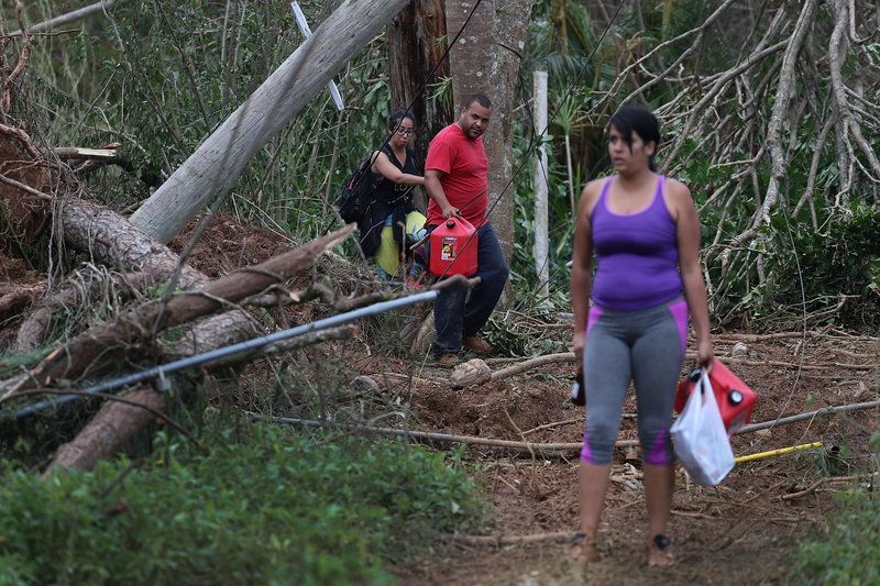 Residents walk around a roadblock caused by a mudslide in Hayales de Coama, Puerto Rico, on Sept. 24, 2017. (Joe Raedle/Getty Images)